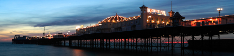 A photo of Brighton pier at night.