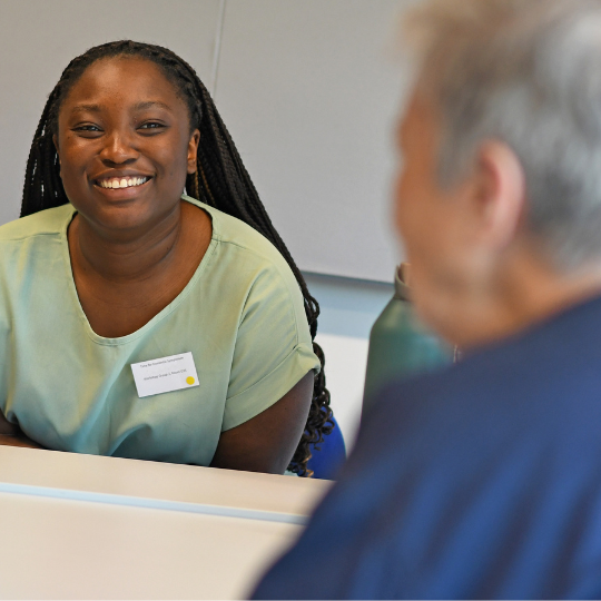 A BSMS student chats with one of the Time for Dementia families