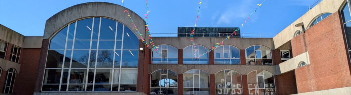 The exterior of Mandela Hall and Falmer House with colourful bunting across the buildings.